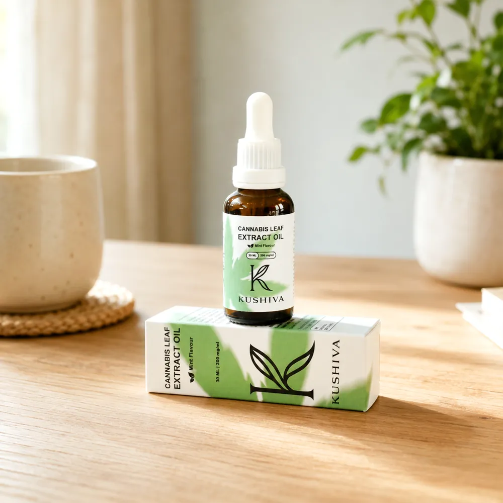 Kushiva Cannabis Leaf Extract Oil 30 ml bottle standing on its carton on a wooden tabletop