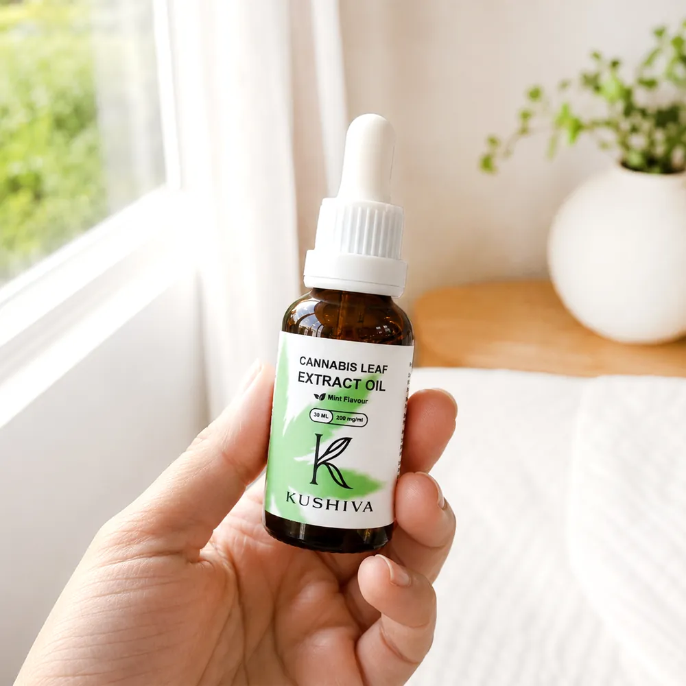 Kushiva Cannabis Leaf Extract Oil 30 ml bottle held in one hand, showing the bottle size