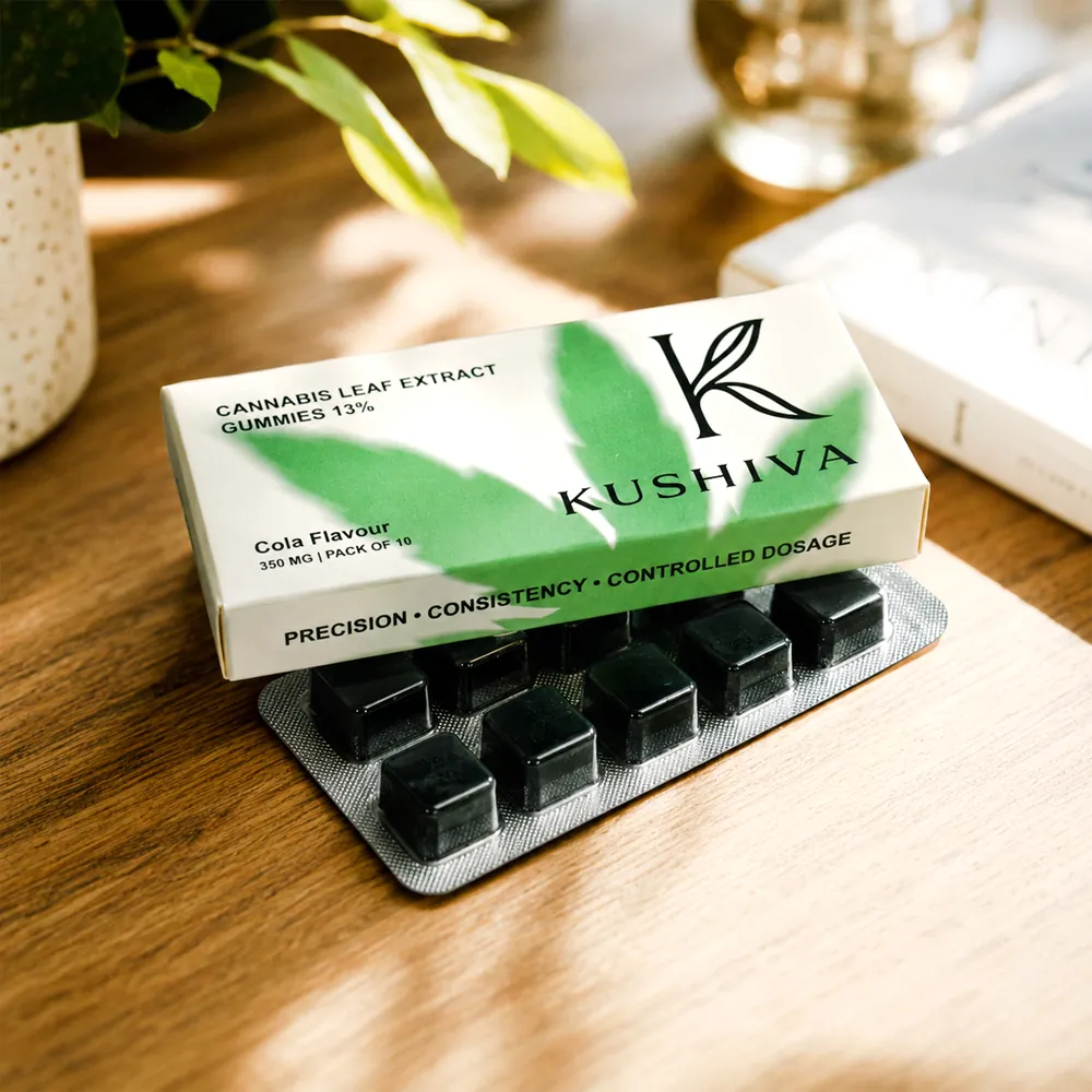 Kushiva Cannabis Leaf Extract Gummies carton resting on its blister pack on a wooden tabletop