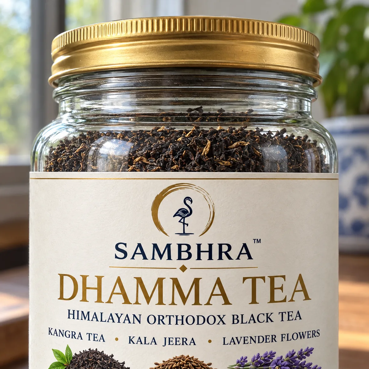 Close view of the Dhamma Tea jar, gold screw cap and the Sambhra flamingo emblem on the cream label