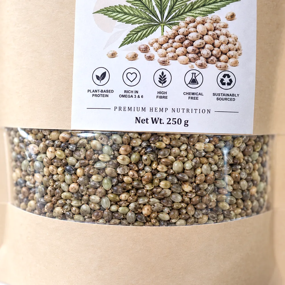Whole organic hemp seeds seen through the pouch window, green grey and cream shells filling the frame